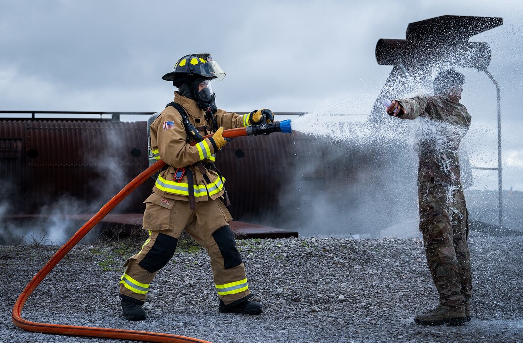 Senior Airman Axel Rojas, 96th Civil Engineer Group, hoses down Airman Aaron Patrimonio