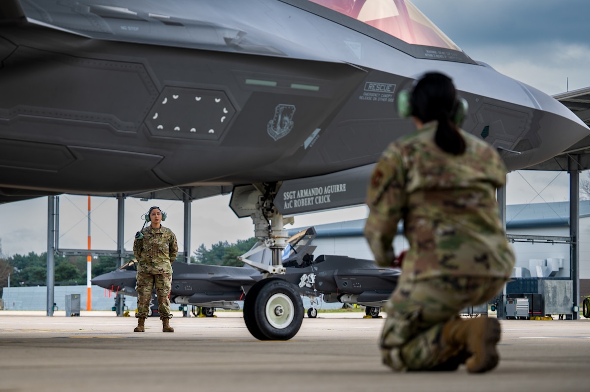 U.S. Air Force Tech. Sgt. Brandy Lopez, 493rd Fighter Generation Squadron crew chief, and Tech. Sgt. Victoria Ortaleza, 493rd FGS avionics technician, prepare to marshal an F-35A Lightning II at RAF Lakenheath, United Kingdom, March 20, 2024. The Liberty Wing's aircrews train regularly to enhance their experience and proficiency in supporting missions that bolster readiness, enhance NATO’s collective defense posture and further integrate air capabilities with allied and partner nations. (U.S. Air Force photo by Airman 1st Class Seleena Muhammad-Ali)