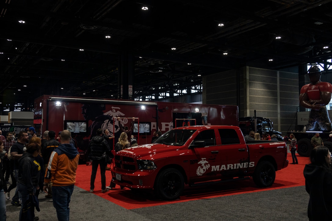 U.S. Marines with Marine Corps Recruiting Station Chicago hold the pull-up challenge at the 2024 Chicago Auto Show, Chicago, IL, Feb. 11, 2024. Every year the Marines arrive to the Chicago Auto Show to interact with the local community with various mediums, the Enhanced Marketing Vehicle that houses the Indoor Simulated Marksmenship Trainer, various Marine Corps vehicles, and the pull-up challenge. (Marine Corps photo by Sgt. Dalton J. Payne)