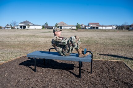 U.S. Air Force Col. Ryan Crowley, Joint Base Anacostia-Bolling and 11th Wing commander, performs the perfect sit-up at one of seven new outdoor fitness workout stations following a Feb. 24, 2024, ribbon cutting at the Bolling Green Park Waterfront on Joint Base Anacostia-Bolling, Washington, D.C. The ceremony marked the completion of the new outdoor fitness stations along the installation’s waterfront.