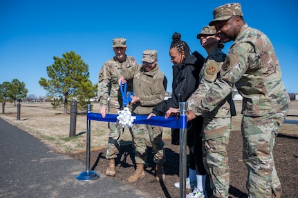 U.S. Air Force Col. Ryan Crowley, Joint Base Anacostia-Bolling and 11th Wing commander, and Chief Master Sgt. Clifford Lawton, JBAB senior enlisted leader and 11th WG command chief, joins the 11th Force Support Squadron in a Feb. 24, 2024, ribbon cutting ceremony to commemorate the installation of the new Bolling Green Park Waterfront outdoor fitness stations. The new equipment includes seven fitness stations evenly distributed along the waterfront at regular intervals.