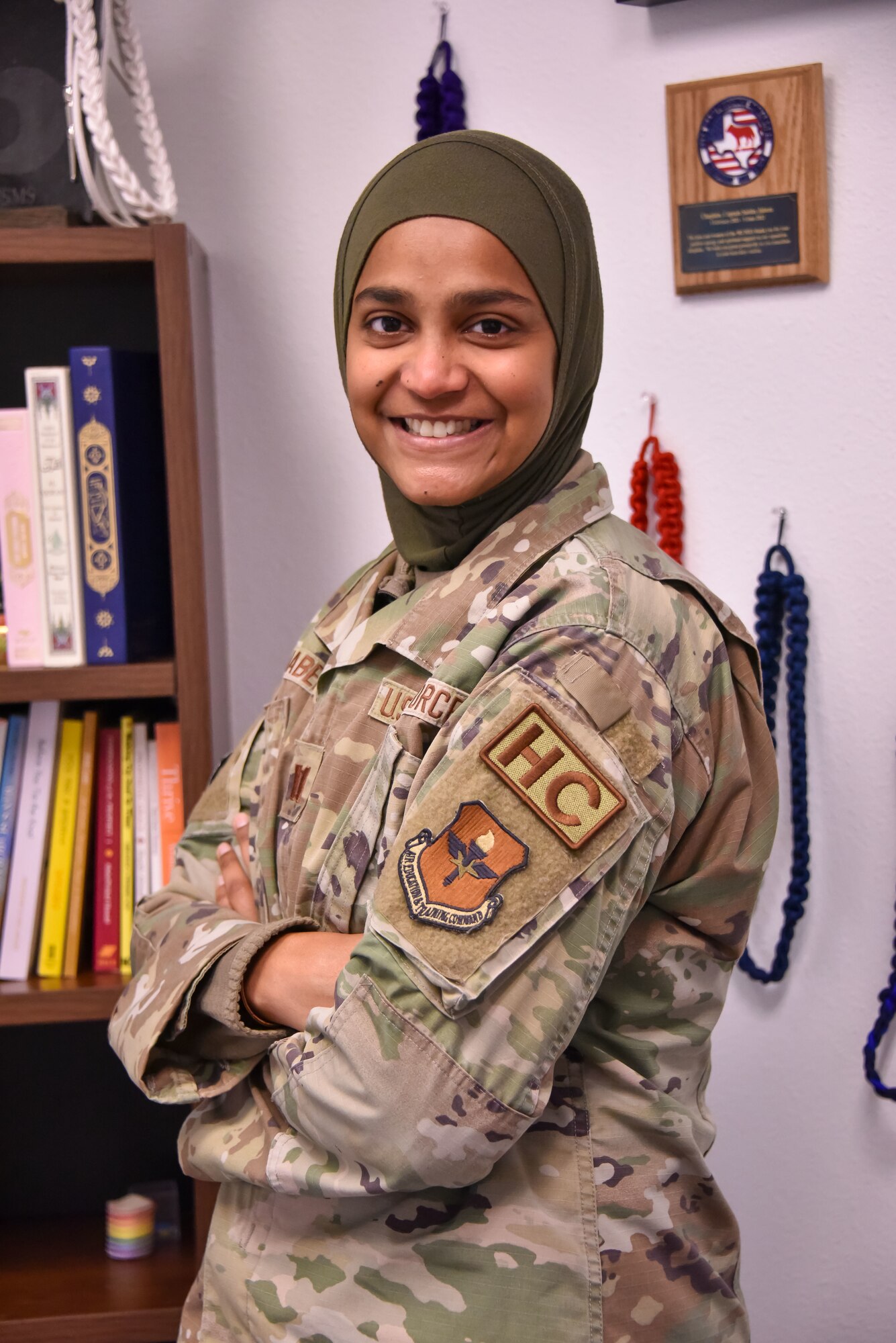 Photo of a military service member wearing a hijab with arms folded.