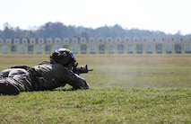 Man in U.S. Army uniforms on outdoor rifle range.