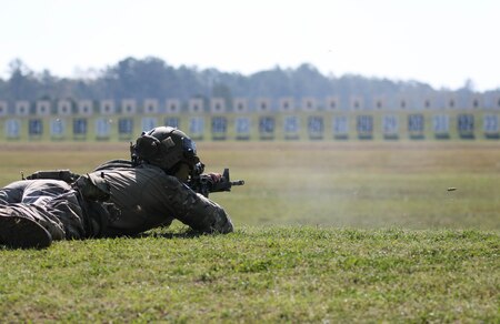 Man in U.S. Army uniforms on outdoor rifle range.