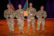 Men in U.S. Army uniforms at awards ceremony.