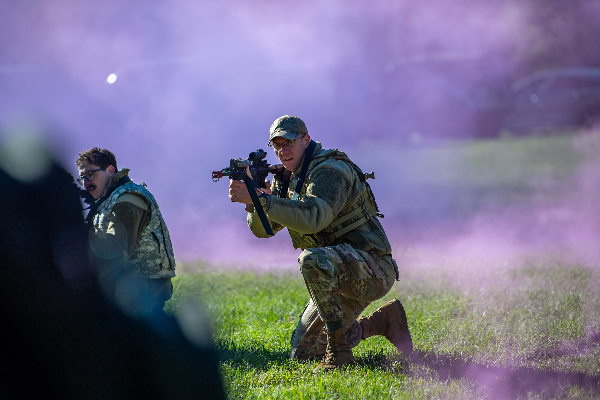 An Airmen practices simulated firing