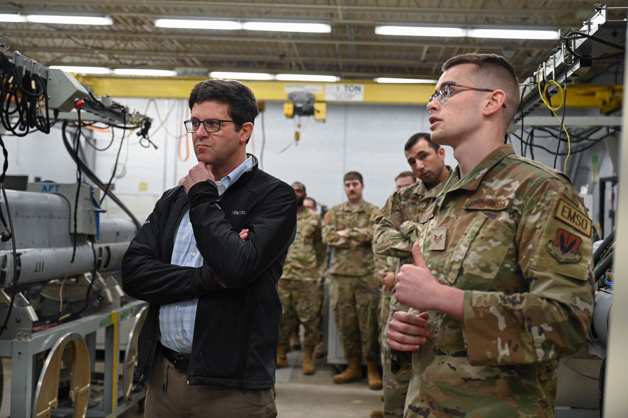 Dr. John Plumb, Assistant Secretary of Defense for Space Policy, receives a brief from U.S. Air Force Staff Sgt. Matthew Berg, 36th Electronic Warfare Squadron EW systems journeyman, during a tour of the 350th Spectrum Warfare Wing at Eglin Air Force Base, Fla., March 11, 2024. The pods are used in testing mission data files that allow aircraft to sense, identify, locate, and counter electronic warfare threats. (U.S. Air Force photo by Capt. Benjamin Aronson)