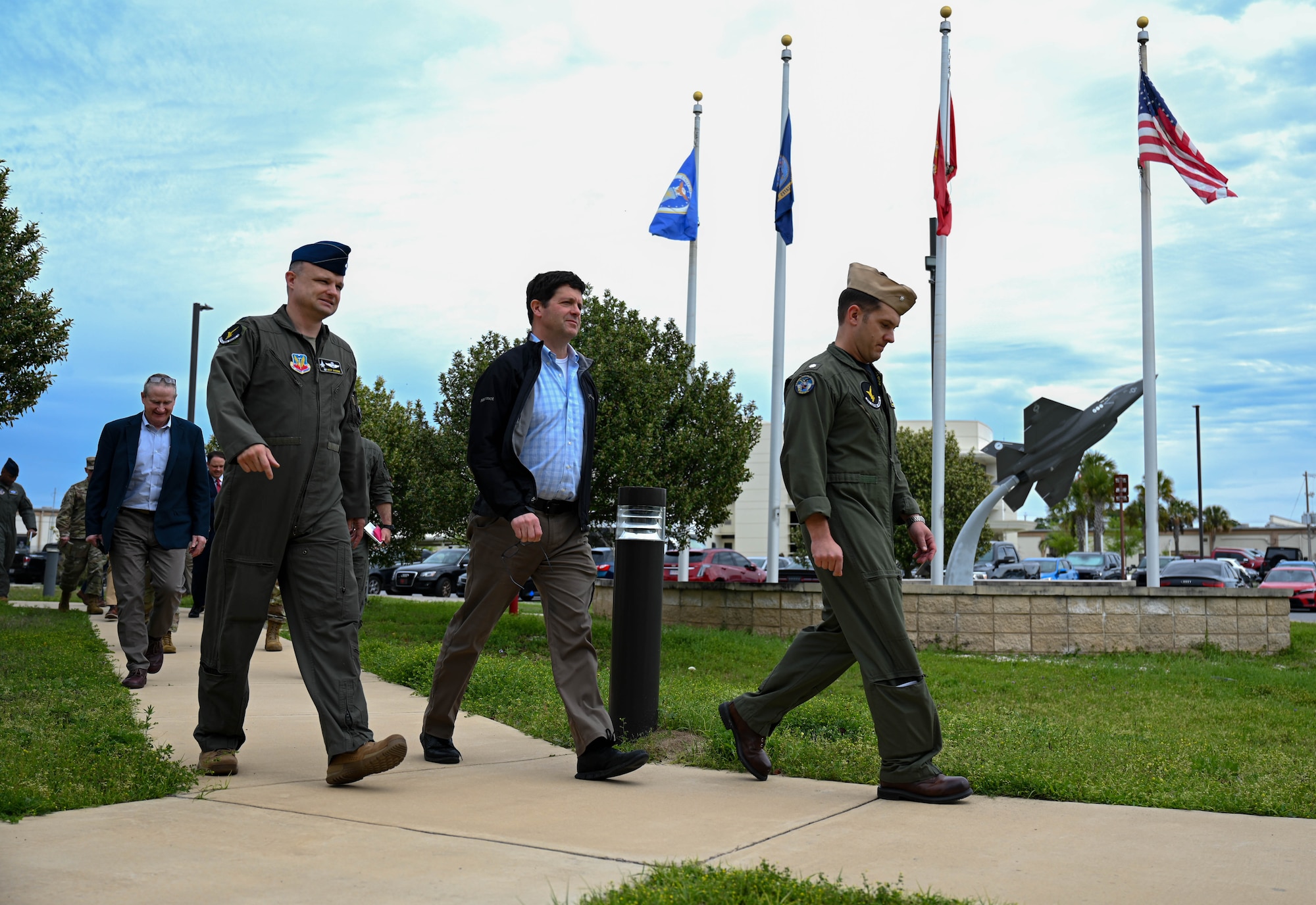U.S. Air Force Lt. Col. Daron Woodside, 513th Electronic Warfare Squadron commander, left, Dr. John Plumb, Assistant Secretary of Defense for Space Policy, center, and U.S. Navy Cmdr. Alexander Sandroni, 513th EWS deputy commander, right, walk outside the 513th EWS building before a series of briefings at Eglin Air Force Base, Fla., March 11, 2024. Plumb visited to the 350th Spectrum Warfare Wing to learn about its mission to deliver adaptive and cutting-edge electromagnetic spectrum capabilities that provide the warfighter a tactical and strategic competitive advantage and freedom to attack, maneuver, and defend. (U.S. Air Force photo by Capt. Benjamin Aronson)