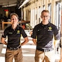 Man and woman in USAMU uniform standing at Indoor Firing range.