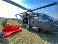 West Virginia National Guard personnel conduct aerial wildland firefighting sorties over Hardy County, West Virginia, on March 22, 2024. West Virginia Jim Justice declared a State of Emergency for four counties in the Eastern Panhandle of the Mountain State due to serious wildland fires that have consumed more than 4,000 acres of woodlands and threaten local communities and residences. Crews flying UH60M and HH60M Blackhawk helicopters from Company C, 1-150th Assault Battalion and Company C, 2-104th General Support Aviation Battalion are utilizing an aerial firefighting system called a “Bambi Bucket” capable of dropping up to 630 gallons of water on active fire lines per sortie to combat the blazes. The delivery method allows firefighters to contain or extinguish the fire in areas of rough and dangerous terrain that ground-based personnel could not safely or easily reach. (Courtesy Photo)