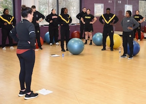 A photo of an exercise coach training Soldiers.