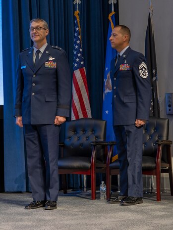 Maj. Gen. Scott Cain, Air Force Research Laboratory commander, and Chief Master Sgt. Carlos E. Labrador, AFRL command chief, stand for the awards presentation at the 2023 Annual Awards Ceremony March 19, 2024, at the Air Force Institute of Technology's Kenney Hall at Wright-Patterson Air Force Base, Ohio. The ceremony recognized enlisted Airmen, Guardians and officers as well as civilians and teams for their 2023 AFRL accomplishments. (U.S. Air Force photo / Keith Lewis)