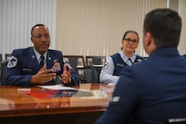Three Airmen interact during a BTZ board.