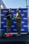 U.S. Marine Corps Sgt. Santiago Ryce, a student with recruiter school, Recruit Training Regiment is awarded for being the 1st place male for the St. Patrick's Day 5k fun run held at Marine Corps Recruit Depot San Diego, California, Mar. 15, 2024. The St. Patrick’s Day 5k fun run is one of many events hosted on the Depot designed to build unit morale and boost esprit de corps. (U.S. Marine Corps photo by Lance Cpl. Janell B. Alvarez)