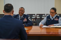 Three Airman interact during a BTZ board.