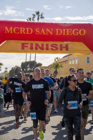 U.S. Marines and civilians with Marine Corps Recruit Depot San Diego kick-off the St. Patrick's Day 5k fun run at MCRD San Diego, California, March 15, 2024. The St. Patrick’s Day 5k fun run is one of many events hosted on the Depot designed to build unit morale and boost esprit de corps. (U.S. Marine Corps photo by Lance Cpl. Janell B. Alvarez)
