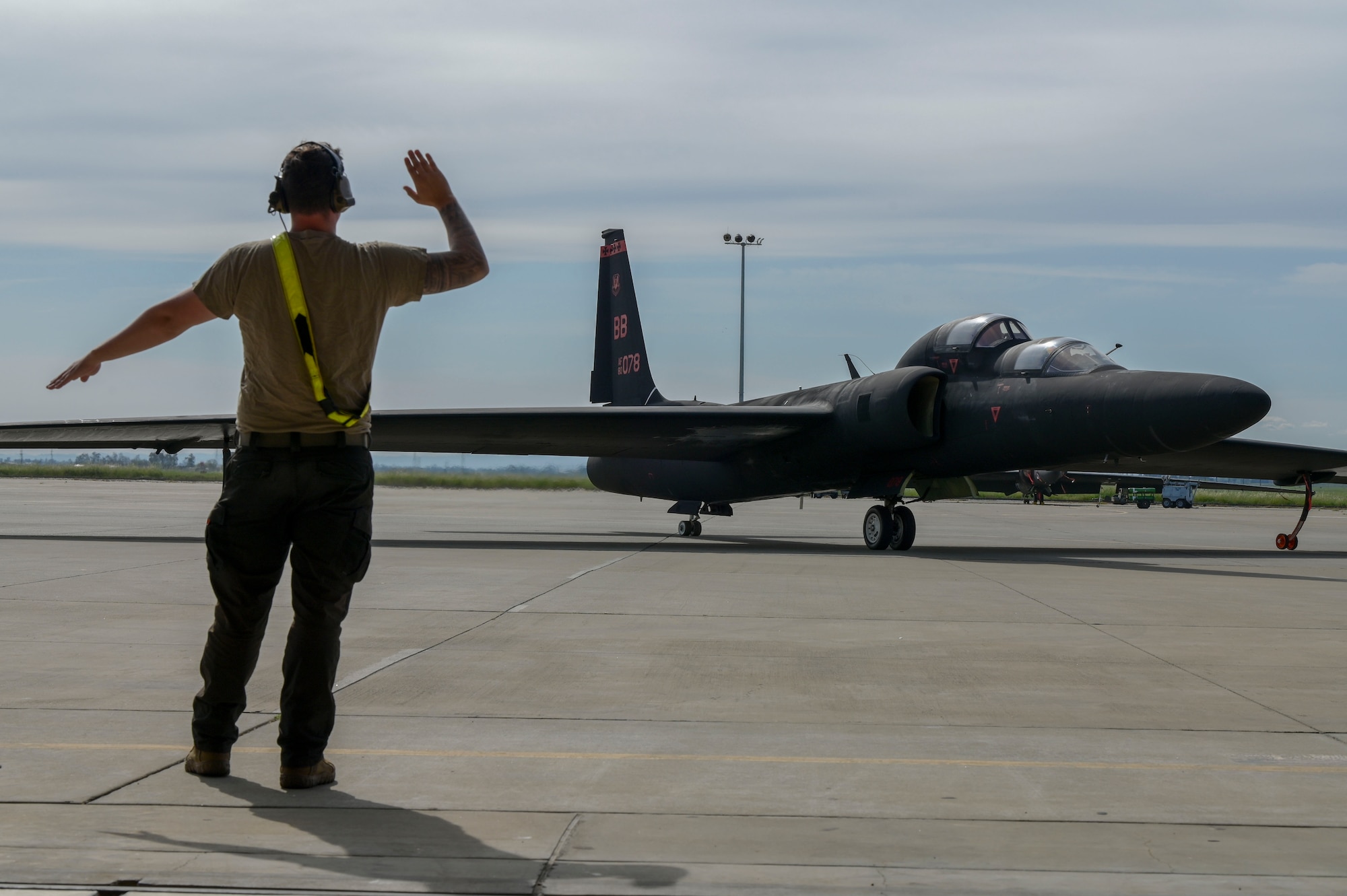 U.S. Air Force Senior Airman Kaya Schmidt, 9th Aircraft Maintenance Squadron crew chief, marshals in TU-2s Dragon Lady 1078 for its return to Beale Air Force Base, California, March 21, 2024.