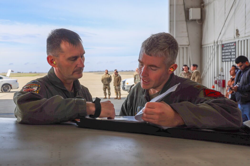U.S Air Force Lt. Col. Joshua, 1st Reconnaissance Squadron student flight commander, and Maj. Brandon, Air Force Life Cycle Management Center (AFLCMC) Detachment 4 chief of flight test operations, discuss plans for co-piloting TU-2S Dragon Lady 1078’s first flight in 1030 days at Beale Air Force Base, California, Feb. 15, 2024.