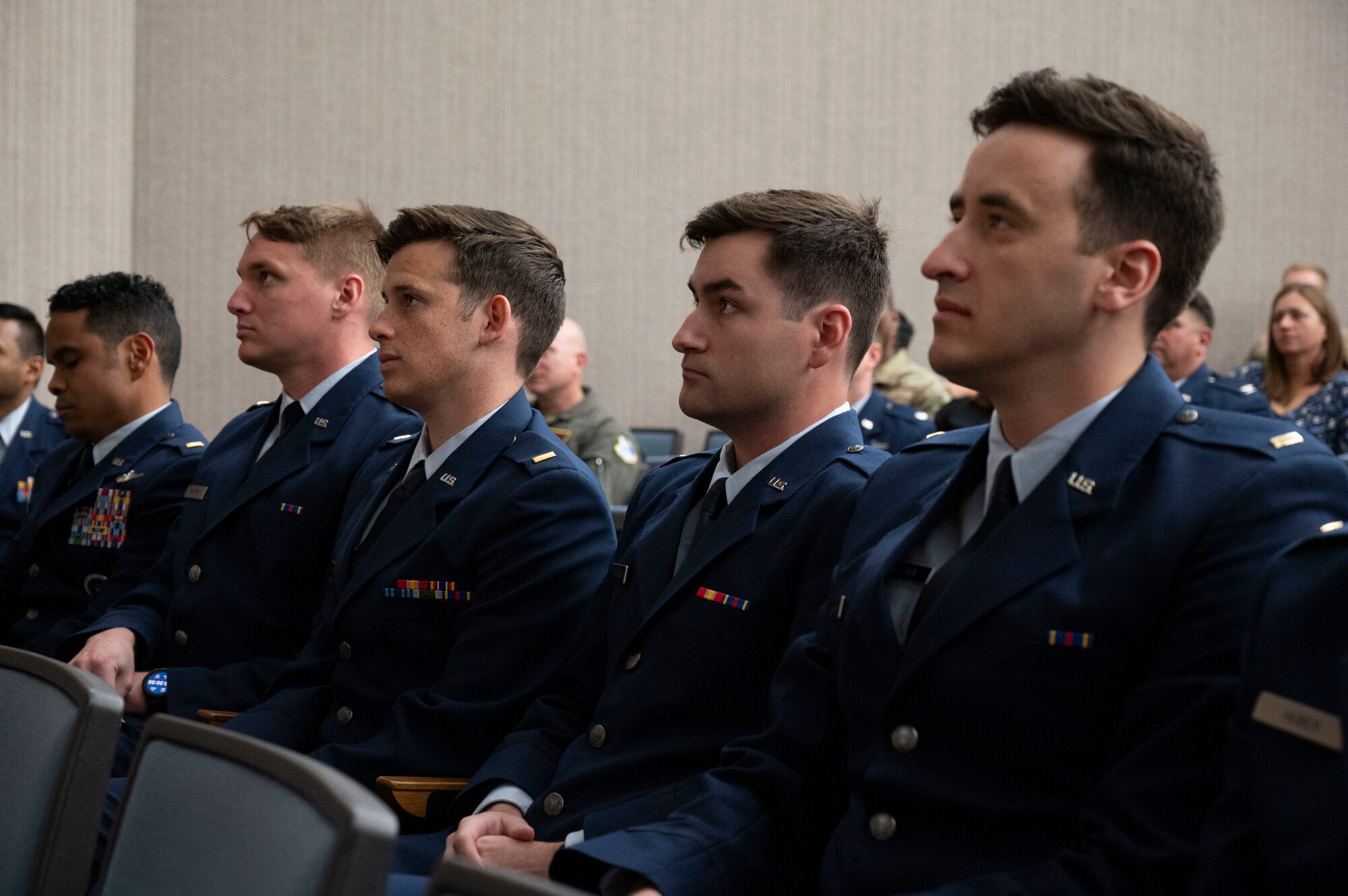 Student pilots of Class 24-07 Undergraduate Pilot Training sit in an auditorium during their graduation ceremony at Laughlin Air Force Base, Texas, March 22, 2024. Nineteen U.S. Air Force officers were awarded silver wings during the ceremony, symbolizing their completion of the UPT Program. (U.S. Air Force photo by Senior Airmen Kailee Reynolds)