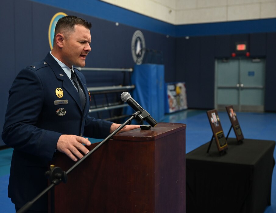 U.S. Air Force 1st Lt. Robert Joiner, 17th Training Wing chaplain, gives the invocation during the 316th Training Squadron Plaque Dedication Ceremony to honor Technical Sgt. Ernest R. Parrish and Staff Sgt. Jacob M. Galliher, at the Mathis Gymnasium, Goodfellow Air Force Base, Texas, March 15, 2024. Parrish and Galliher were both airborne cryptologic language analysts trained at Goodfellow. (U.S. Air Force photo by Airman 1st Class Evelyn J. D’Errico)