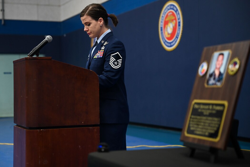 U.S. Air Force Master Sgt. Jessica Abad, 316th Training Squadron instructor, speaks during the 316th TRS Plaque Dedication Ceremony to honor Technical Sgt. Ernest R. Parrish and Staff Sgt. Jacob M. Galliher, at the Mathis Gymnasium, Goodfellow Air Force Base, Texas, March 15, 2024. Abad reflected on the commitment and sacrifice that Airmen make daily in their career. (U.S. Air Force photo by Airman 1st Class Evelyn J. D’Errico)