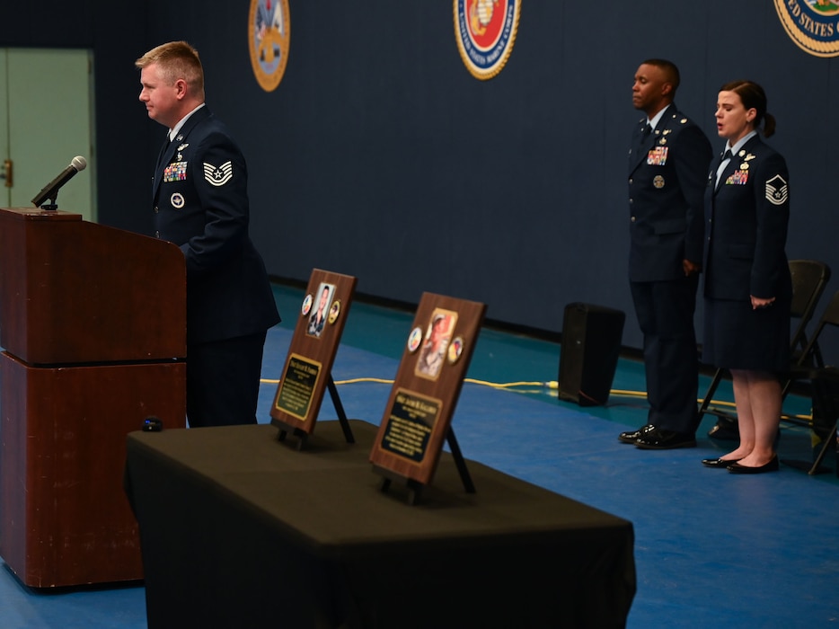 U.S. Air Force Technical Sgt. Eric Hobbs, 316th Training Squadron instructor, emcees during the 316th TRS Plaque Dedication Ceremony to honor Technical Sgt. Ernest R. Parrish and Staff Sgt. Jacob M. Galliher, at the Mathis Gymnasium, Goodfellow Air Force Base, Texas, March 15, 2024. Parrish and Galliher were both airborne cryptologic language analysts trained at the Goodfellow Air Force Base, Texas. (U.S. Air Force photo by Airman 1st Class Evelyn J. D’Errico)