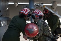 From left, U.S. Navy Aviation Ordnancemen Ivania Gomez-Diaz, Melani Nunez and Kelvin Fells, assigned to Electronic Attack Squadron (VAQ) 135, Naval Air Station Whidbey Island, download an advanced anti-radiation guided missile during Red Flag-Nellis 24-2 at Nellis Air Force Base, Nevada, March 13, 2024.