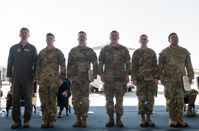 Airmen pose for a photo.
