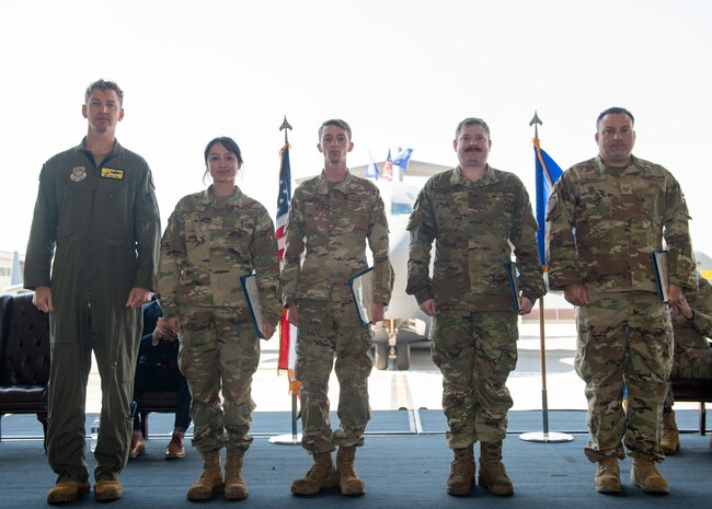 Airmen pose for a photo.