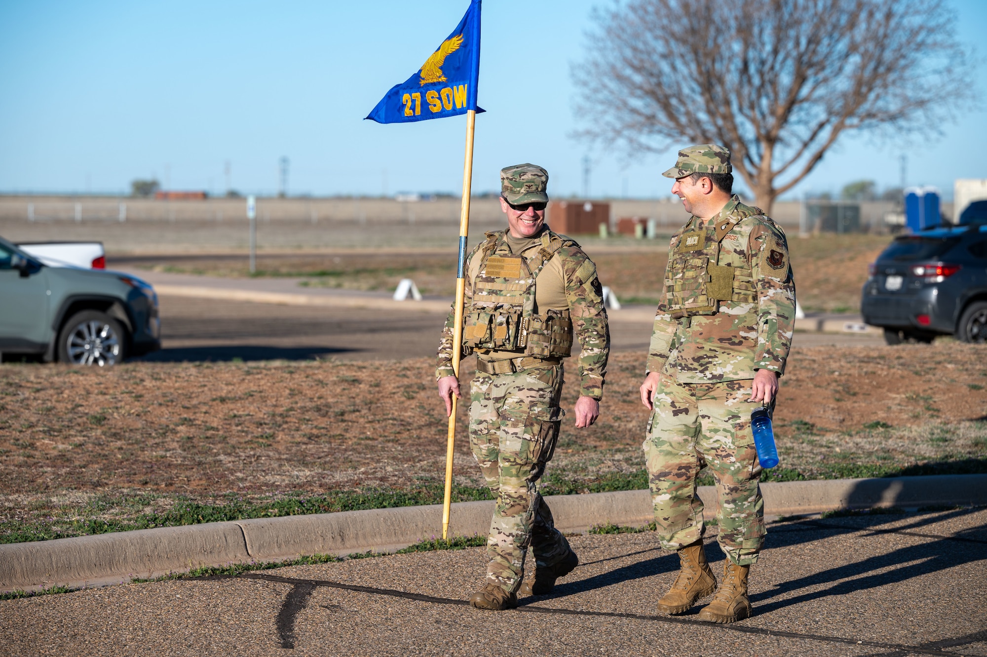 U.S. Air Force Col. Jeremy Bergin, 27th Special Operations Wing commander, left, and Col. Brent Greer, 27 SOW deputy commander, right, carry the 27 SOW guidon during the 3rd Annual Steadfast Ruck March at Cannon Air Force Base, N.M., March 22, 2024. The memorial event honored the men of the 27th Bombardment Group and others who were part of the original Bataan Death March, a forced movement of 75,000 U.S. and Filipino soldiers from the Bataan Peninsula in the Philippines. (U.S. Air Force photo by 2nd Lt. Charles Moye)