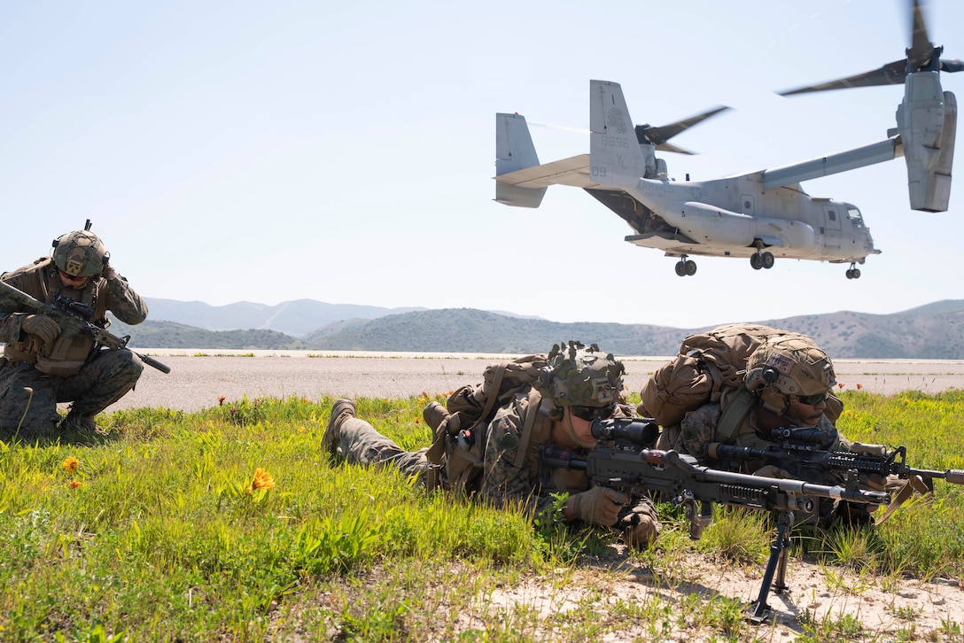 U.S. Marines assigned to Bravo Company, Battalion Landing Team 1/5, 15th Marine Expeditionary Unit, at a landing zone as an MV-22B Osprey attached to Marine Medium Tiltrotor Squadron (VMM) 165 (Reinforced), 15th MEU, takes off during training at Marine Corps Base Camp Pendleton, California, March 21, 2024.