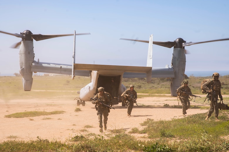 U.S. Marines assigned to Bravo Company, Battalion Landing Team 1/5, 15th Marine Expeditionary Unit, disembark an MV-22B Osprey attached to Marine Medium Tiltrotor Squadron (VMM) 165 (Reinforced) 15th MEU, at a landing zone during training at Marine Corps Base Camp Pendleton, California, March 21, 2024.