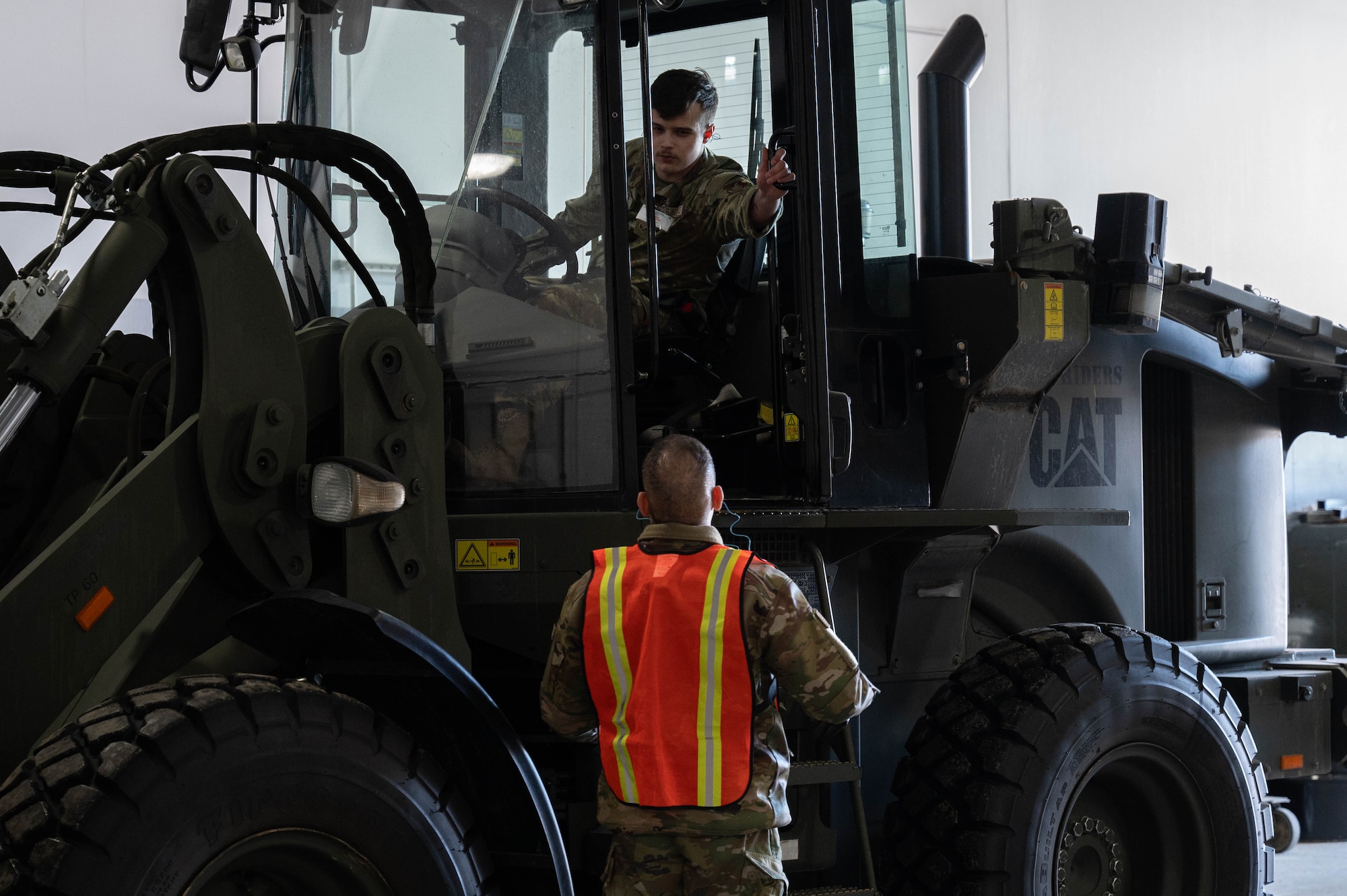 U.S. Air Force Airman Cole Cornell (top), 354th Logistics Readiness Squadron ground transportation apprentice, coordinates crate movement with Airman 1st Class Kevin Atari, 354th LRS vehicle maintenance apprentice, during Arctic Gold 24-2 at Eielson Air Force Base, Alaska, March 19, 2024.