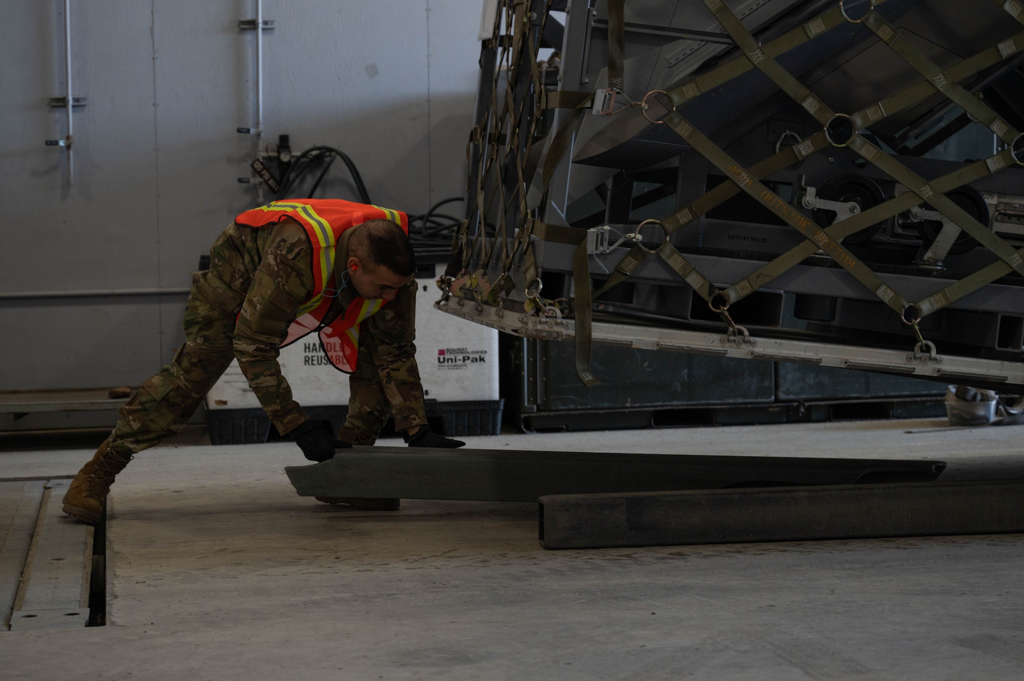 U.S. Air Force Airman 1st Class Kevin Atari, 354th Logistics Readiness Squadron vehicle maintenance apprentice, lays down pallet boards during Arctic Gold 24-2 at Eielson Air Force Base, Alaska, March 19, 2024.