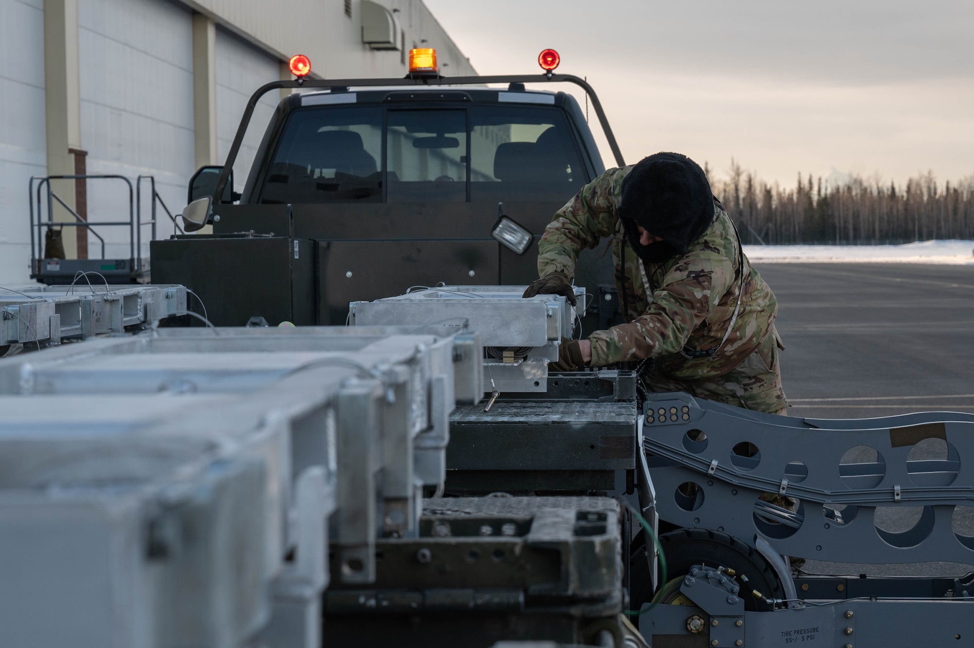 U.S. Air Force Staff Sgt. Sergio Buelna, 355th Fighter Generation Squadron weapons load crew chief, prepares loading equipment during Arctic Gold 24-2 at Eielson Air Force Base, Alaska, March 20, 2024.