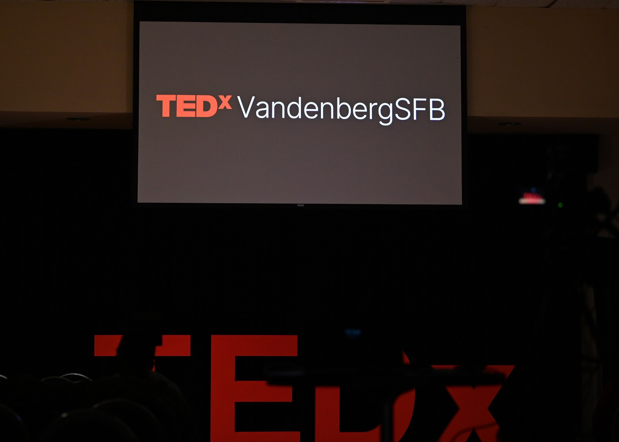 A sign is displayed during a conference.