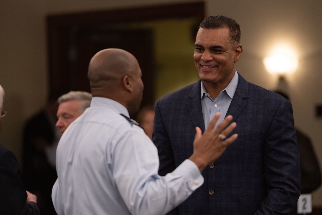 U.S. Air Force Col. Todd E. Randolph, left, 316th Wing and installation commander, speaks with Chad Steele, Baltimore Ravens senior vice president of communications, during the honorary commander induction ceremony at Joint Base Andrews, Md., March 21, 2024.