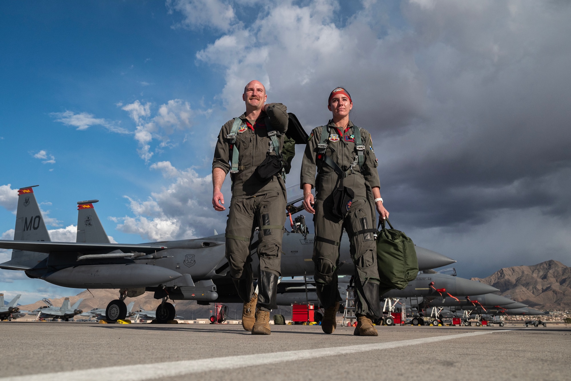 Major Nathan Persons, left, and Capt. Annie Braun, Weapon Systems Officer, assigned to the 366th Fighter Wing, Mountain Home Air Force Base (AFB), Idaho, depart an F-15E Strike Eagle after finishing a Red Flag-Nellis 24-2 mission at Nellis AFB, Nevada, March 18, 2024.
