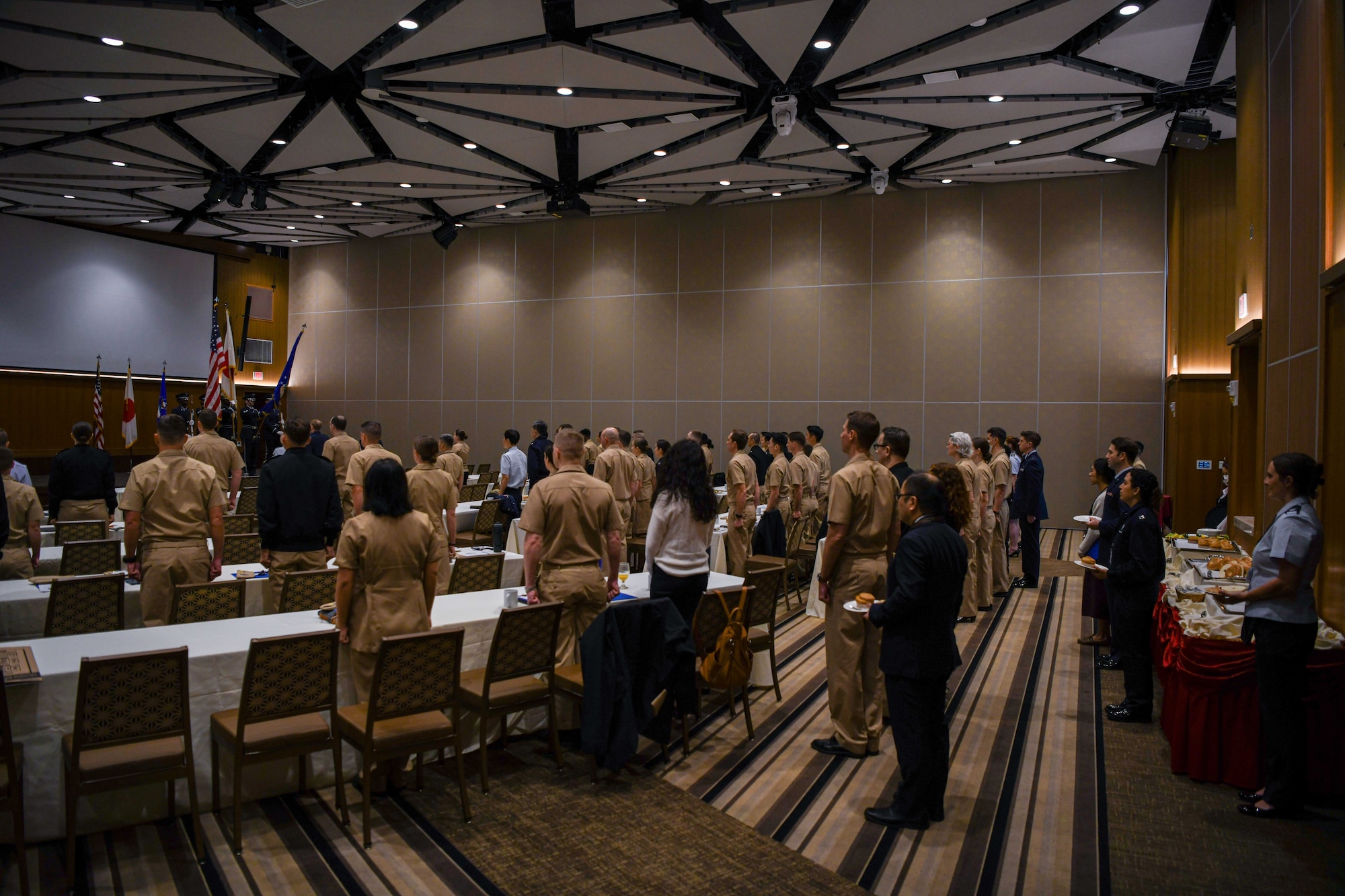 Service members stand at attention.