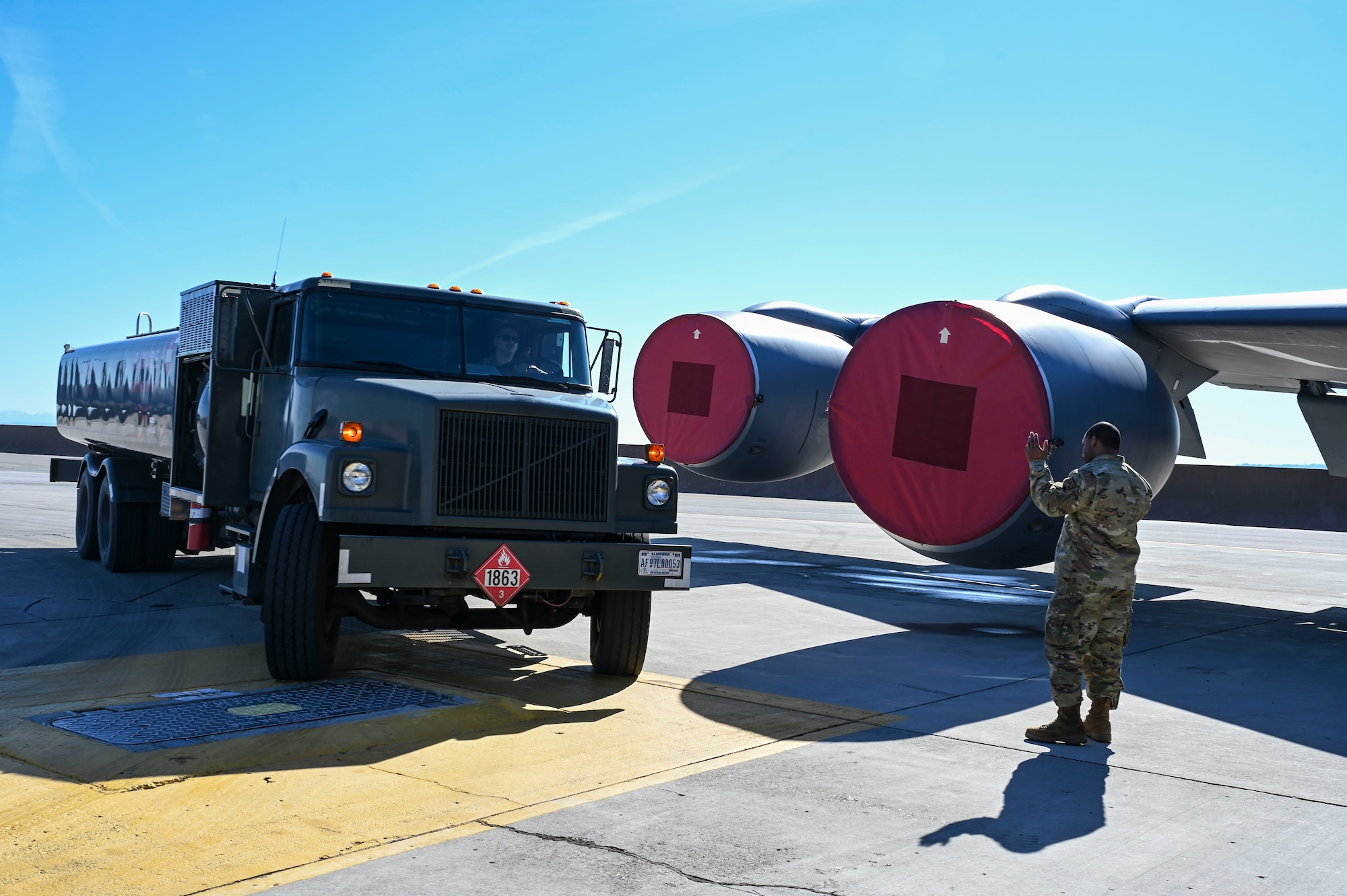 Airman marshals fuels truck