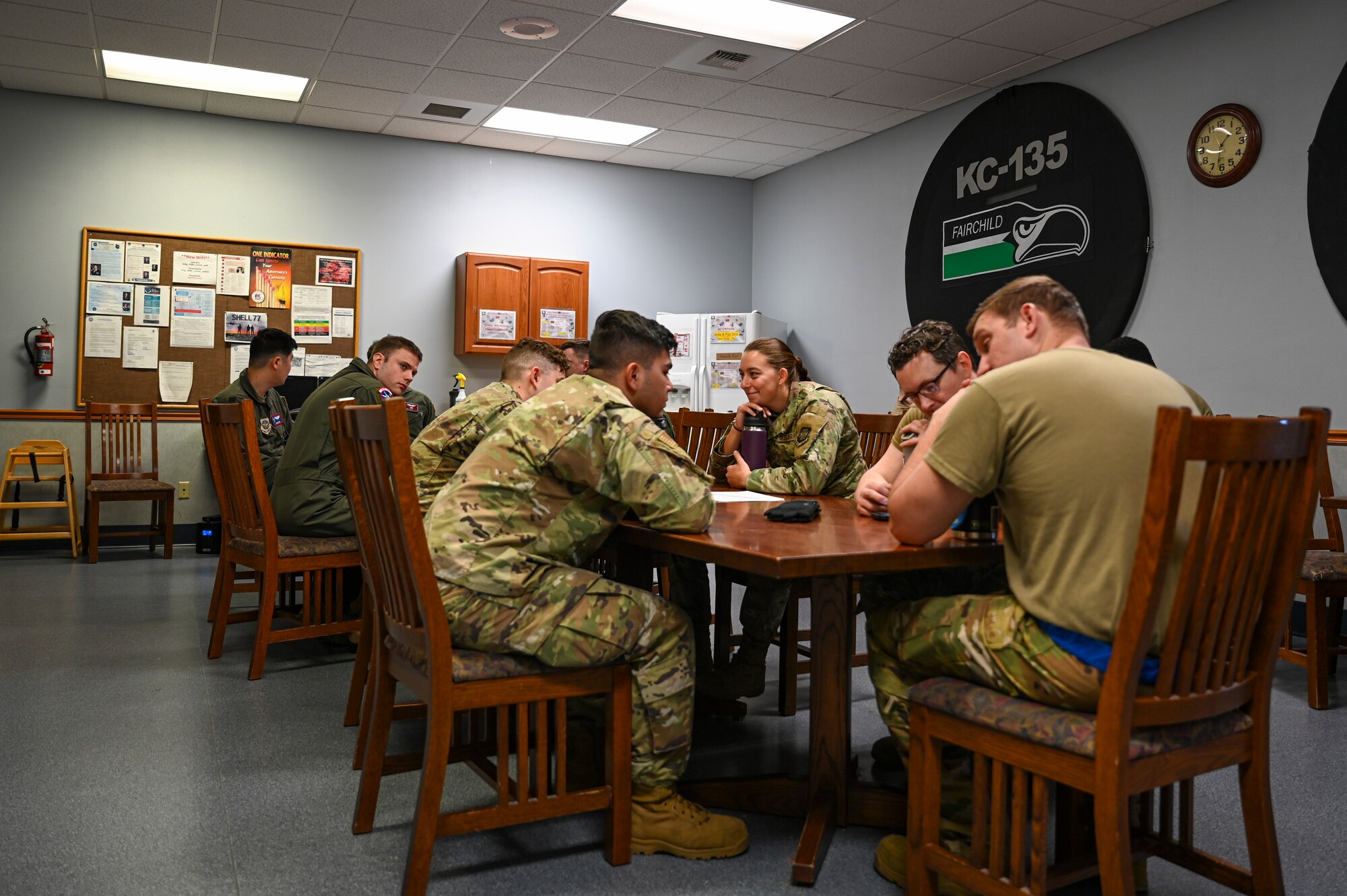 Airmen sit at table