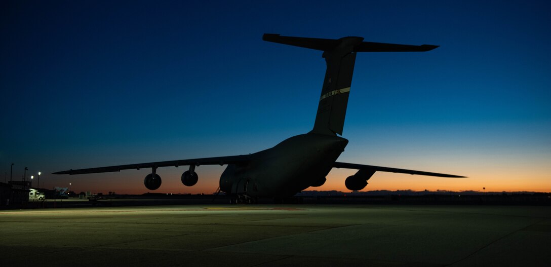 A U.S. Air Force C-5M Super Galaxy sits parked on the flightline