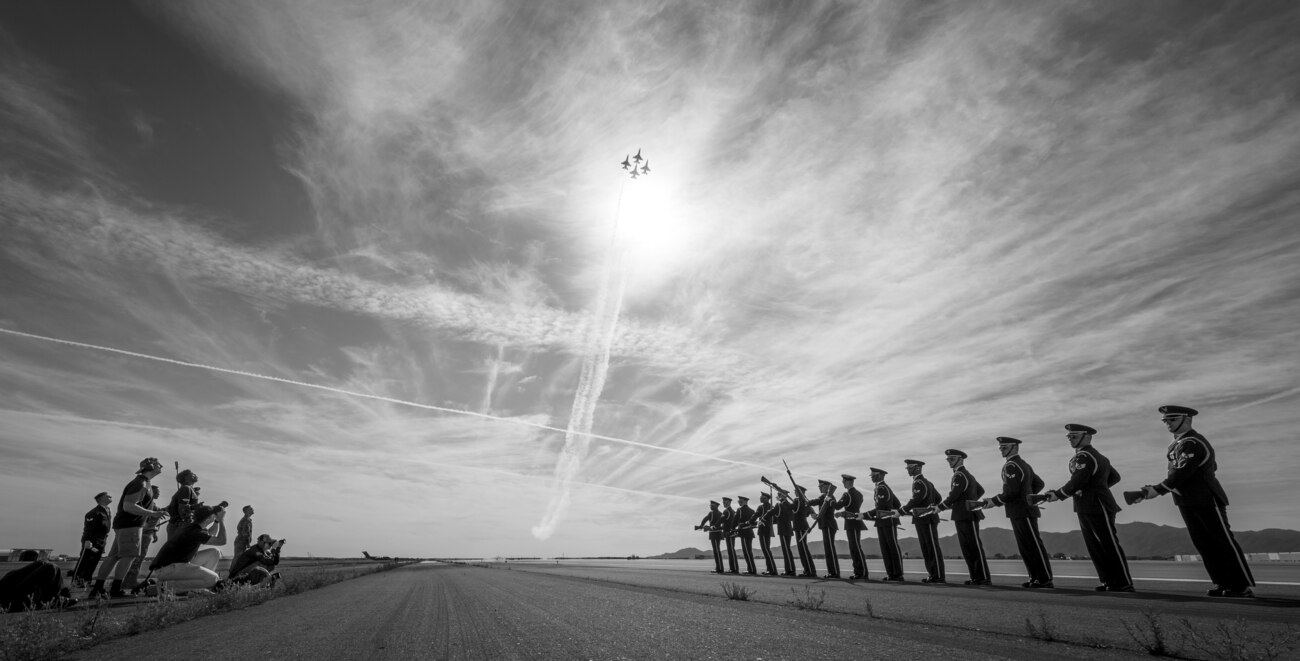 The U.S. Air Force Honor Guard practices a formation as F-16 Fighting Falcons, assigned to the U.S. Air Force Demonstration team, the "Thunderbirds," pass above them prior to Luke Days 2024 on March 22, 2024, at Luke Air Force Base, Arizona.