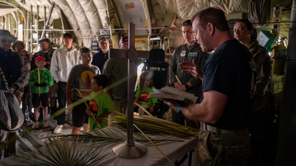 U.S. Air Force Capt. Adam Roe, 56th Fighter Wing chaplain, provides a Palm Sunday service in a C-130J Super Hercules aircraft assigned to the 317th Airlift Wing, Dyess Air Force Base, during the Luke Days airshow on March 24, 2024, at Luke Air Force Base, Arizona.