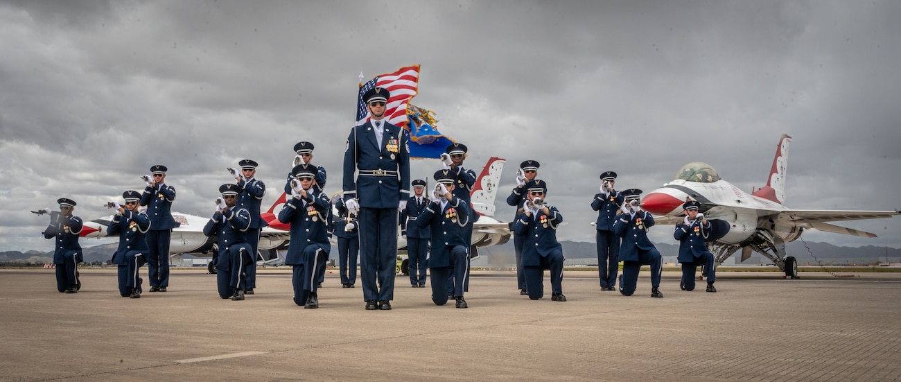 The U.S. Air Force Honor Guard stands in formation in front of a U.S. Air Force F-16 Fighting Falcons, assigned to the U.S. Air Demonstration team, the "Thunderbirds," during the Luke Days airshow on March 24, 2024, at Luke Air Force Base, Arizona.