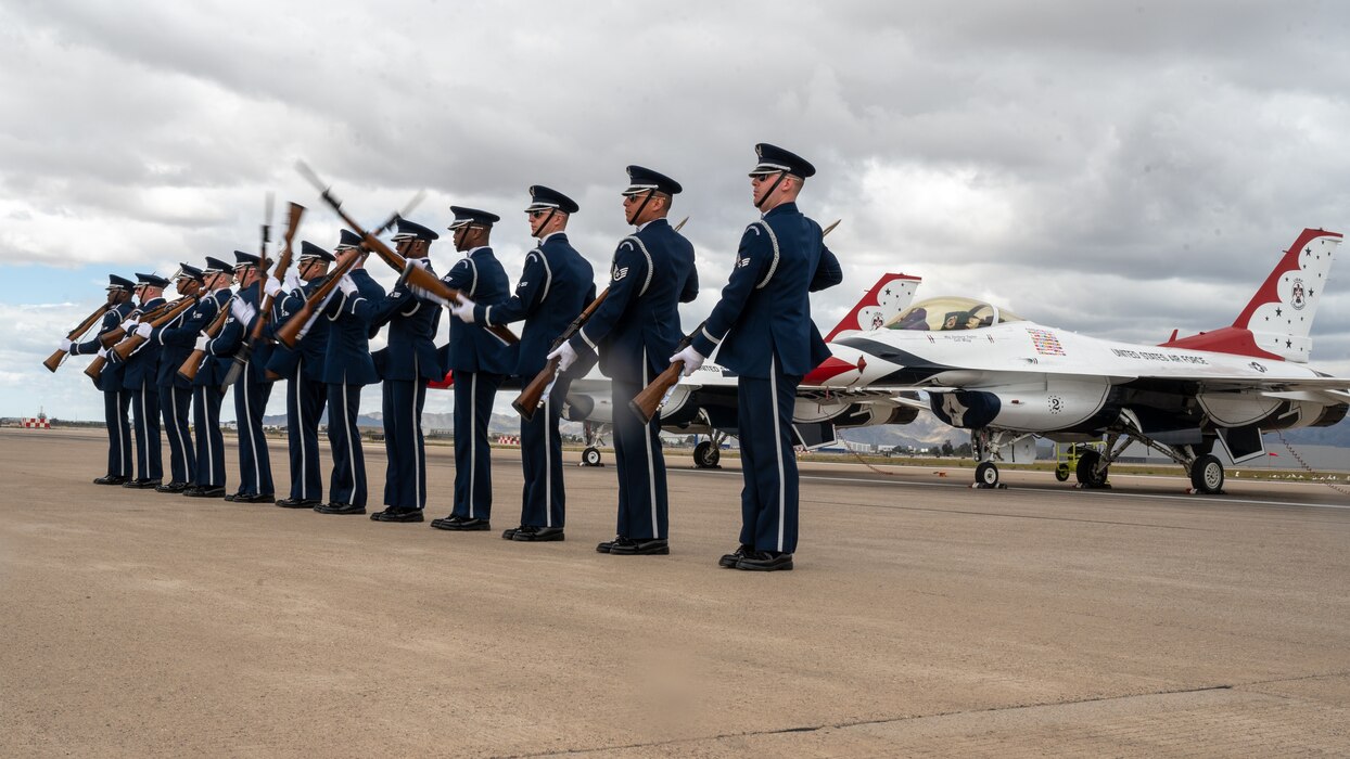 The U.S. Air Force Honor Guard stands in formation in front of a U.S. Air Force F-16 Fighting Falcons, assigned to the U.S. Air Demonstration team, the "Thunderbirds," during the Luke Days airshow on March 24, 2024, at Luke Air Force Base, Arizona.