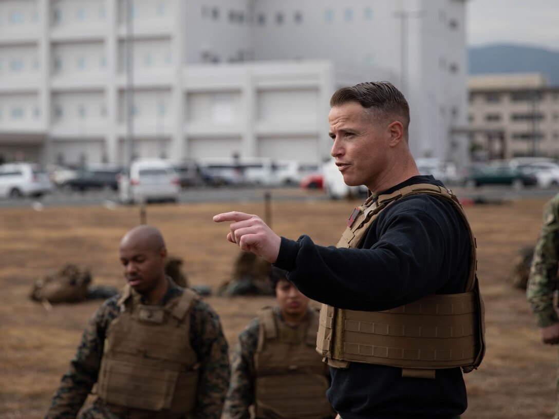 U.S. Marine Corps Gunnery Sgt. Mikael Marcy, a brig supervisor with Headquarters and Headquarters Squadron, Marine Corps Air Station Iwakuni, instructs a group of Marines during the culminating event of a Marine Corps martial arts instructor course at MCAS Iwakuni, Japan, Dec. 14, 2023. Graduates of the 15-day course become qualified Martial Arts Instructors, empowered to independently lead and facilitate courses, assisting lower-belt Marines in their progression towards higher belts. (U.S. Marine Corps photo by Lance Cpl. Colin Thibault)