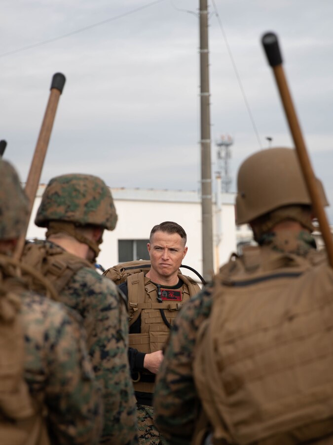 U.S. Marine Corps Gunnery Sgt. Mikael Marcy, a brig supervisor with Headquarters and Headquarters Squadron, Marine Corps Air Station Iwakuni, instructs a group of Marines during the culminating event of a Marine Corps martial arts instructor course at MCAS Iwakuni, Japan, Dec. 14, 2023. Graduates of the 15-day course become qualified Martial Arts Instructors, empowered to independently lead and facilitate courses, assisting lower-belt Marines in their progression towards higher belts. (U.S. Marine Corps photo by Lance Cpl. Colin Thibault)