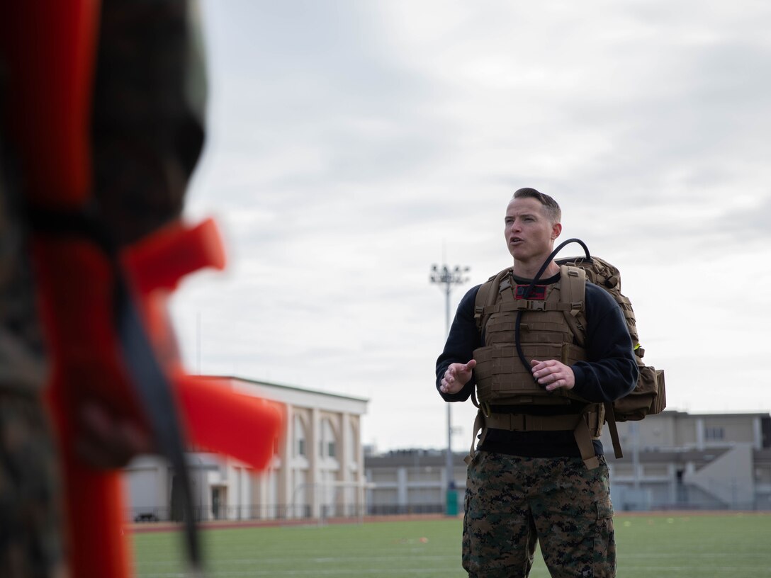 U.S. Marine Corps Gunnery Sgt. Mikael Marcy, a brig supervisor with Headquarters and Headquarters Squadron, Marine Corps Air Station Iwakuni, instructs a group of Marines during the culminating event of a Marine Corps martial arts instructor course at MCAS Iwakuni, Japan, Dec. 14, 2023. Graduates of the 15-day course become qualified Martial Arts Instructors, empowered to independently lead and facilitate courses, assisting lower-belt Marines in their progression towards higher belts. (U.S. Marine Corps photo by Lance Cpl. Colin Thibault)