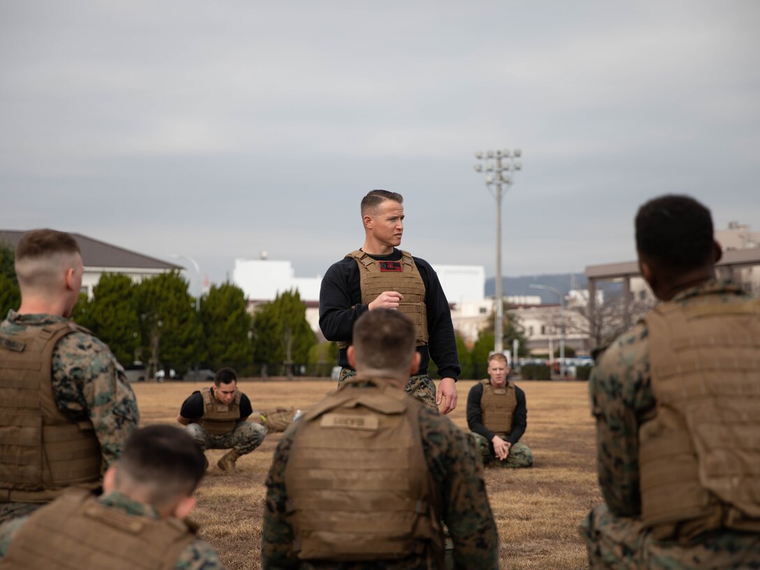 U.S. Marine Corps Gunnery Sgt. Mikael Marcy, a brig supervisor with Headquarters and Headquarters Squadron, Marine Corps Air Station Iwakuni, instructs a group of Marines during the culminating event of a Marine Corps martial arts instructor course at MCAS Iwakuni, Japan, Dec. 14, 2023. Graduates of the 15-day course become qualified Martial Arts Instructors, empowered to independently lead and facilitate courses, assisting lower-belt Marines in their progression towards higher belts. (U.S. Marine Corps photo by Lance Cpl. Colin Thibault)